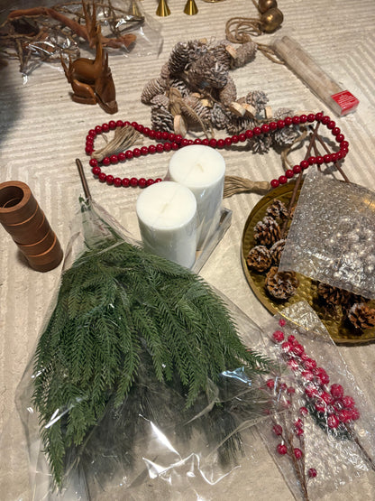 Decorative items including candles, greenery, and festive elements on a table.